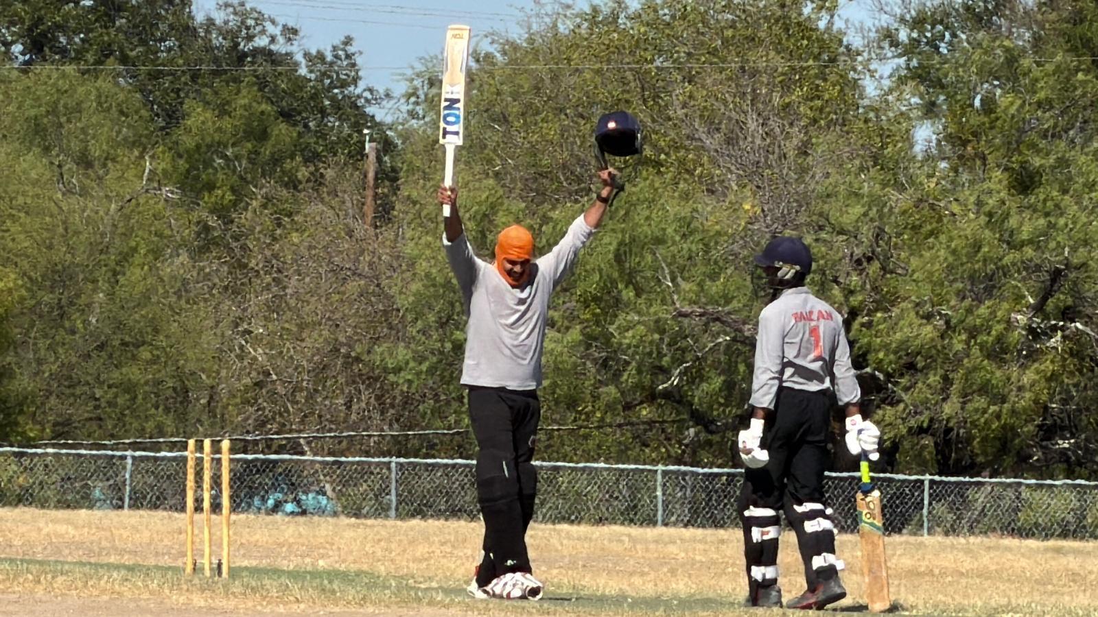 Islanders celebrating a century with teammates embracing on the field