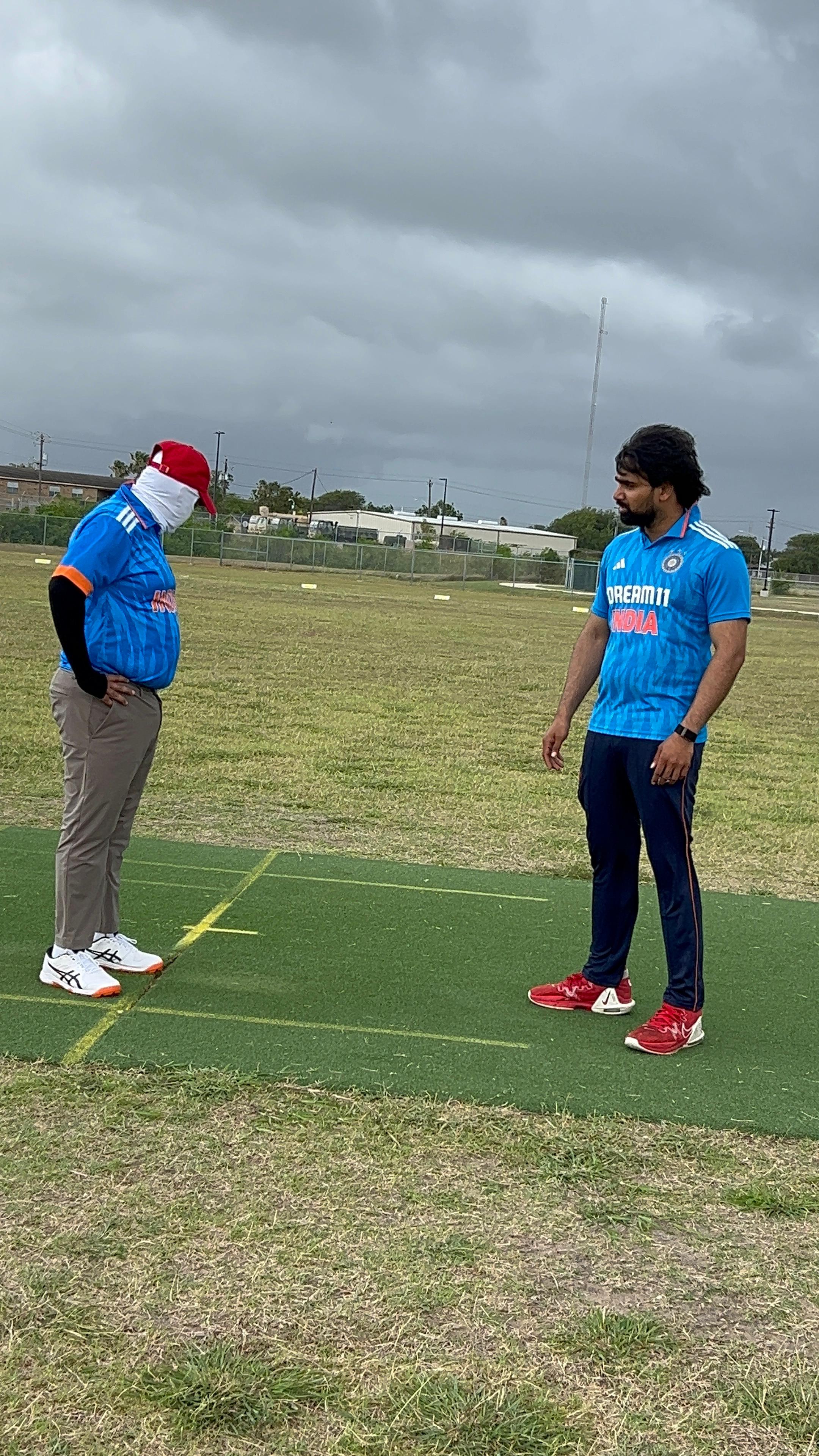 Akhil Reddy Danda and Dr. Vishnu Reddy walking the pitch before a game